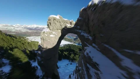FPV flight through a natural rock arch in the Pyrenees Stock Footage 346003599