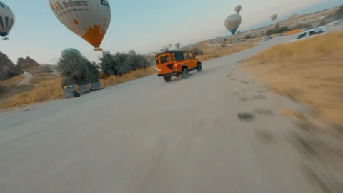 FPV Fly-Through – Color Graded – Jeep Driving in Cappadocia Turkey Stock Footage 311129374