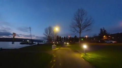 FPV fly through path lit up by lights at dusk 動画素材 219820073