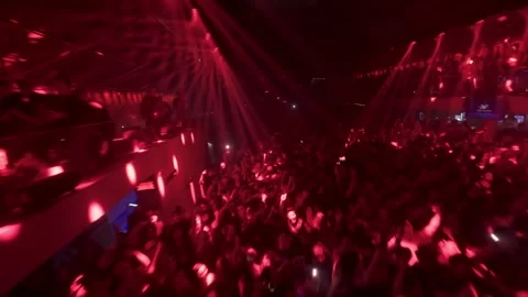 FPV Glide Through Red Lighting Over Club Crowd Vídeo Stock 327435836