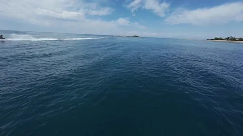 FPV Low Flight Over Sea Past Moving Jet Ski Stock Footage 309038375