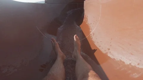 FPV - a man slides along the flow of a water slide. Active recreation, water Video stock 115055250