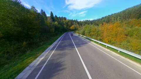 FPV motion views of highway in wild mountains. Speed biker extreme racer riding Stock Footage 182059595