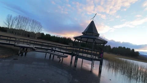 FPV orbit around lakeside pavilion at Laguna La Zeta near Esquel Argentina Stock Footage 336658913