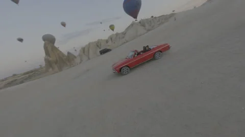 FPV Orbit Shot – LOG Flat Version – Red Tourist Car in Cappadocia Turkey Stock Footage 311103040