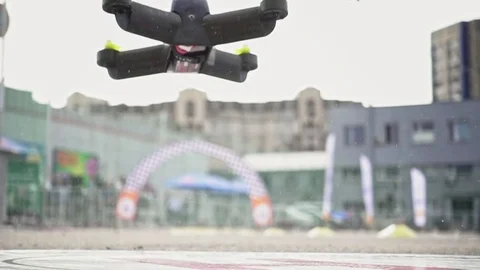 FPV racing drone taking off the ground in slowmo Stock Footage 80834234
