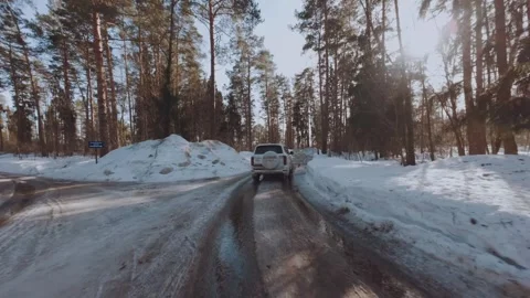 FPV shooting of a car in the forest, an SUV driving along a forest road Stock-Footage 330766964