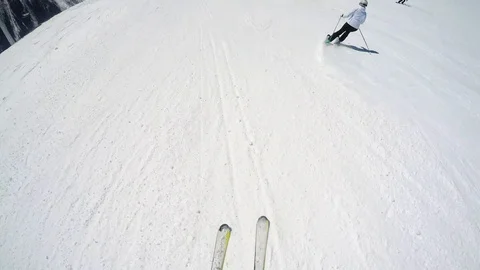 FPV Skier slopes down hill following shadow. Good weather for skiing. Action Stock Footage 109179212