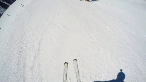 FPV Skier slopes down hill following shadow. Good weather for skiing. Action Stock Footage 109179359