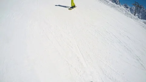 FPV Skier slopes down hill following shadow. Good weather for skiing. Action Stock Footage 109180695