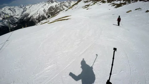 FPV snowboarder shots action camera skier riding ahead. Sunny day Stock Footage 131464738