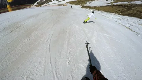 FPV snowboarder shots action camera on monopod upset snowboarder riding ahead Stock Footage 133884702