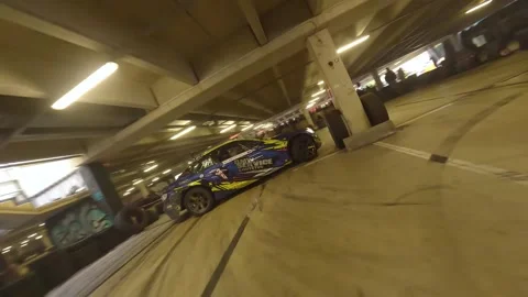 FPV Solo Drift: Smooth Maneuvers Between Garage Columns Stock Footage 327036099