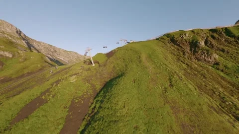 FPV sport drone flying over ski resort with cableway morning mountains in summer Stock Footage 336624557