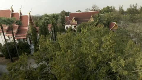 FPV Sunset Pull Back Shot of Wat Khaemaed  Chiang Mai Stock Footage 332794766