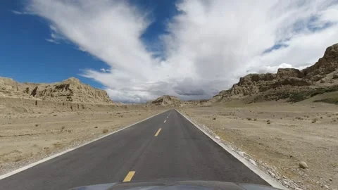 FPV view of driving a car in a road trip across Tibet in China Stock Footage 142047047