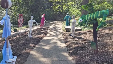 -FPV-Walking path between Halloween scarecrows Stock Footage 287804521