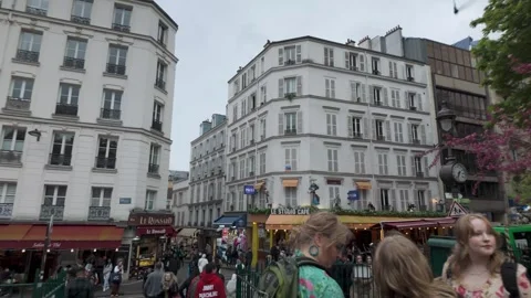 FPV walking through bustling Montmartre street corner in Paris, France Stock Footage 313896928