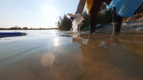 FPV on water closeup view of unrecognizable person collecting plastic rubbish Stock-Footage 172534639
