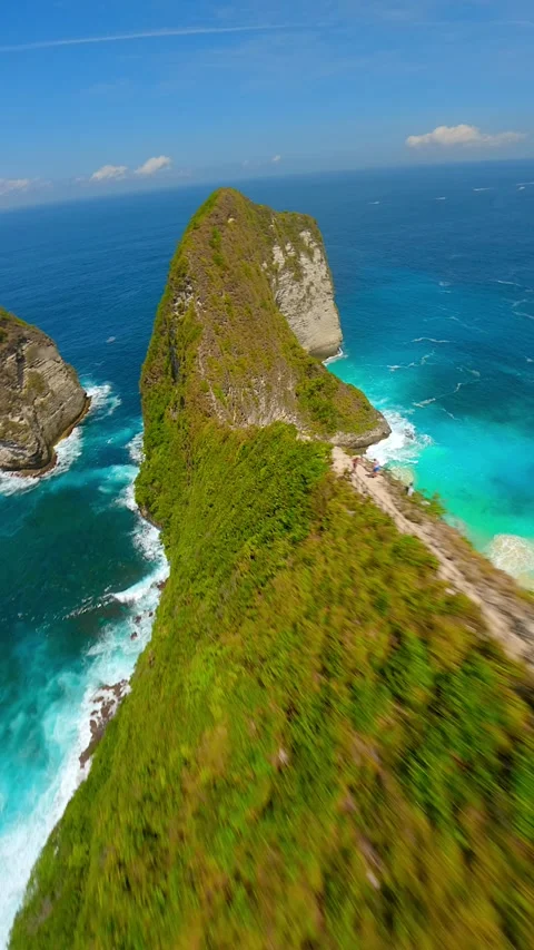 FPVdrone flight over cliffs and turquoise sea at Kelingking Beach Bali Indonesia Stock Footage 310305253