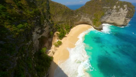 FPVdrone flight over cliffs and turquoise sea at Kelingking Beach Bali Indonesia Stock Footage 312911035