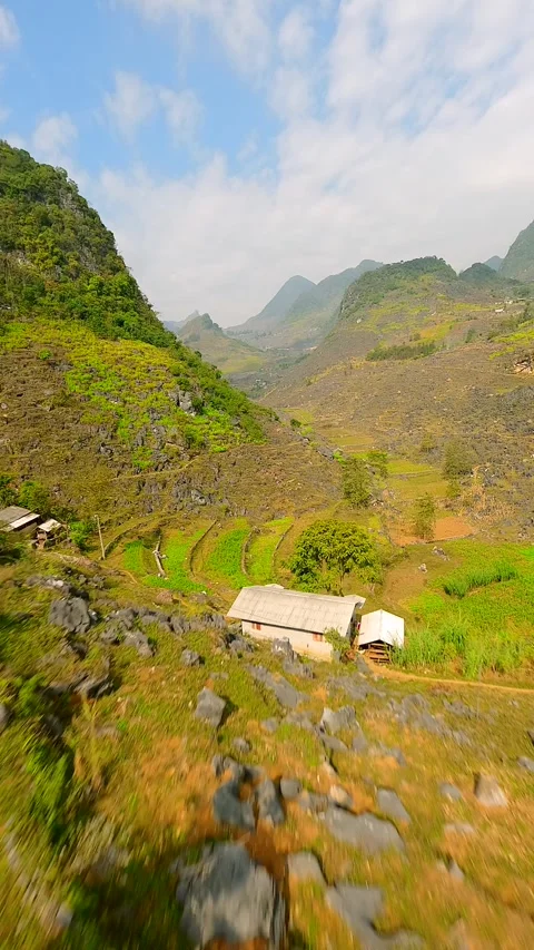 FPVdrone flight over winding mountain road and scenic valley in Ha Giang Vietnam Video stock 306517447