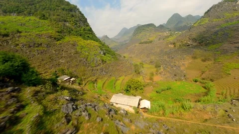 FPVdrone flight over winding mountain road and scenic valley in Ha Giang Vietnam Stock Footage 306519171