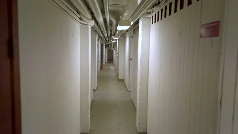 FPW walking through a basement Stock Footage 212349047