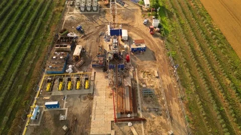 Fracking drilling for shale gas in a field Stock Footage 281240059
