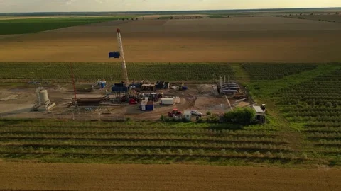 Fracking drilling for shale gas in a field Stock Footage 281240206