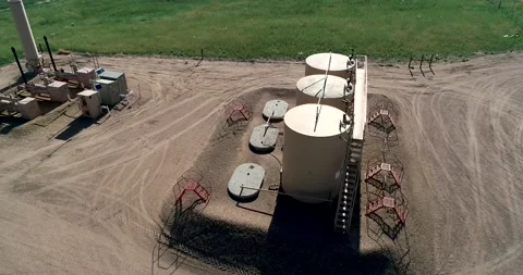 Fracking pad with three large petroleum tanks.  June 2022. Stock Footage 197755378