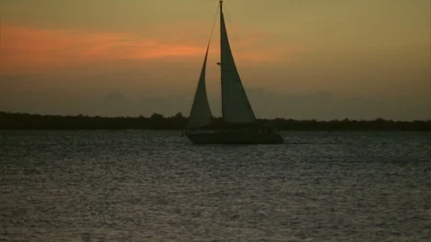 Fractional Rig Sloop sailing boat sailing right to left with sunset Video stock 95601271