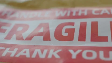 Fragile sticker on cardboard box packaging handle with care thank you message Stock Footage 332578334