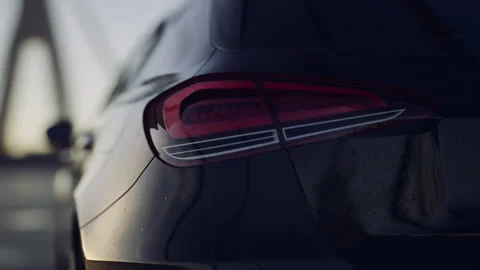 A fragment of a black car shot from behind against the backdrop of an urban l Stock Footage 282851353