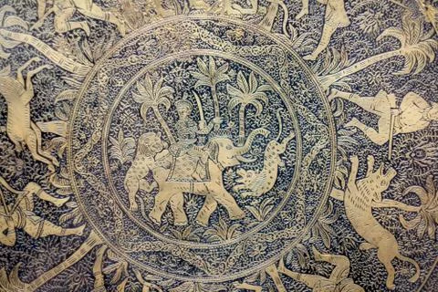 Fragment of the brass surface of the panel with chased images of hunting scen Stock Photos