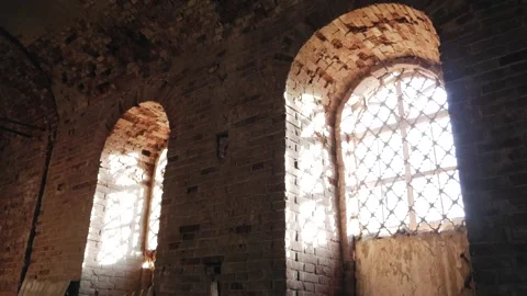 Fragment of a brick wall with a window with a lattice of a medieval church Stock Footage 147692645
