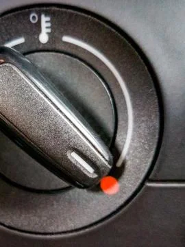 Fragment of car temperature controller in red area set at high values. Icon o Stock Photos