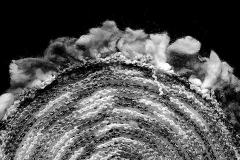 Fragment of a crocheted circle from melange threads based on a plastic canvas Stock Photos
