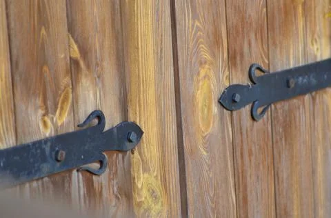 Fragment of a door with iron hinges Stock Photos