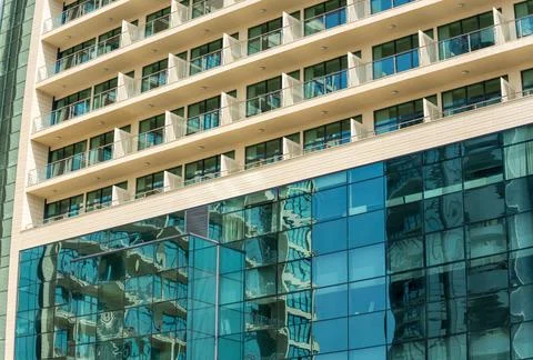 A fragment of the facade of a high-rise building with mirrored blue wind Stock Photos