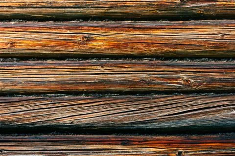 Fragment of the facade of a log wall. Rustic log wall horizontal wood backgro Stock Photos