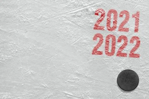 Fragment of a hockey arena with red lettering and puck Stock Photos