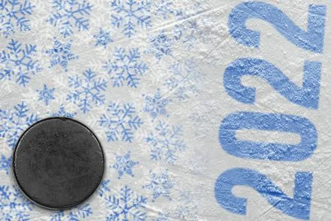 A fragment of an ice arena with a winter pattern and a hockey puck Stock Photos