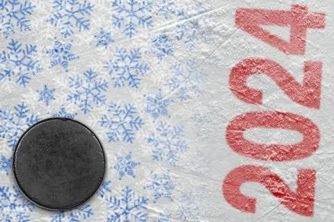 A fragment of an ice arena with a winter pattern and a hockey puck Stock Photos