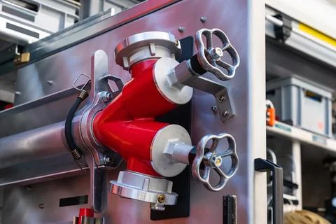 Fragment of the inside of a fire engine with valves for connecting water hoses. Stock Photos