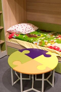 Fragment  interior children&amp;#39;s room with a table in  form of  puzzle Stock Photos