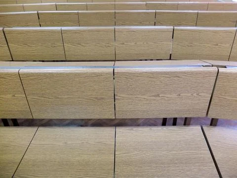 Fragment of  lecture hall with empty rows of wooden desks Stock Photos