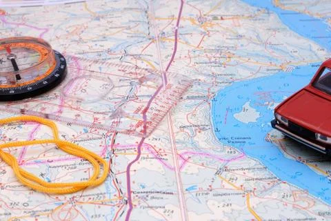 Fragment of a map with a compass and model of the automobile Stock Photos
