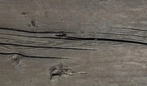 A fragment of an old rustic board with coal dust inclusions Stock Photos