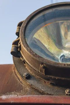 Fragment of old train headlight. Old rusty locomotive, close up. Stock Photos
